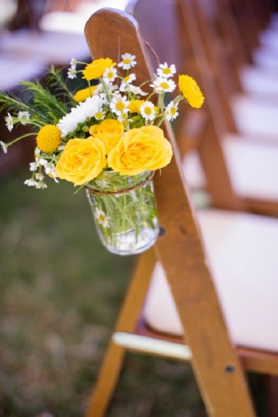 wedding aisle chair decorated with yellow flowers in jars for yellow weddding themes for 2023 yellow and navy