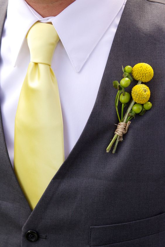 bridegroom in navy suit yellow tie yellow billy balls and green fruits corsage for yellow weddding themes for 2023 yellow and lavender