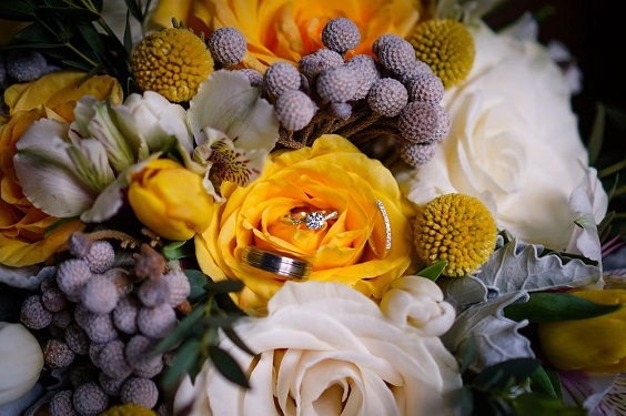 wedding rings hidden in yellow and lavender flowers for yellow weddding themes for 2023 yellow and lavender