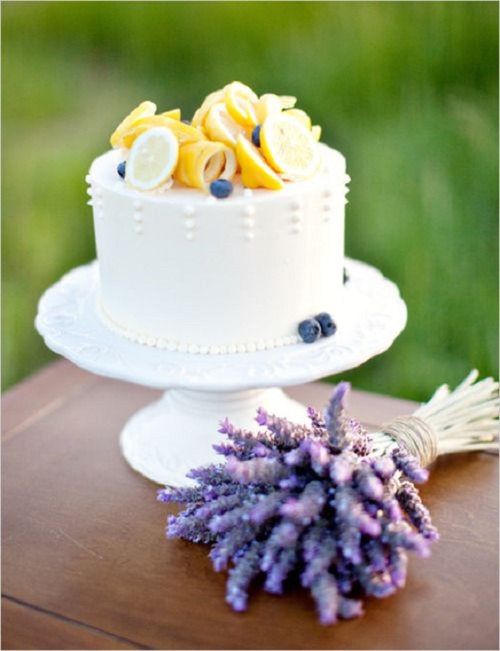 white wedding cake dotted with yellow lemon and lavender for yellow weddding themes for 2023 yellow and lavender