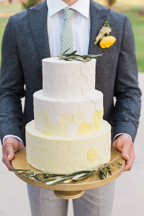 white and yellow wedding cake dotted with greenery for yellow weddding themes for 2023 yellow and green