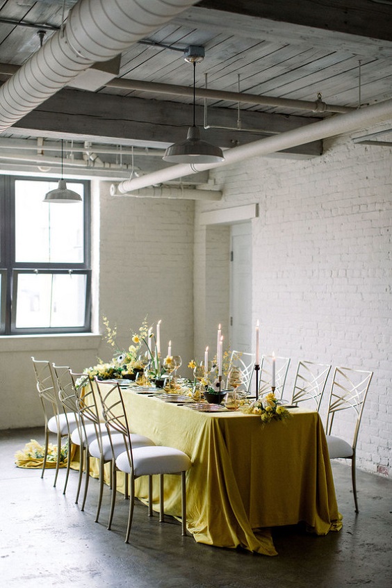 sweetheart wedding table with yellow tablecloth yellow flower and white canlde wedding centerpieces for yellow weddding themes for 2023 yellow black and white
