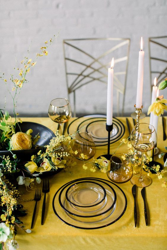 yellow wedding tablecloth black drinkware and white candles for yellow weddding themes for 2023 yellow black and white