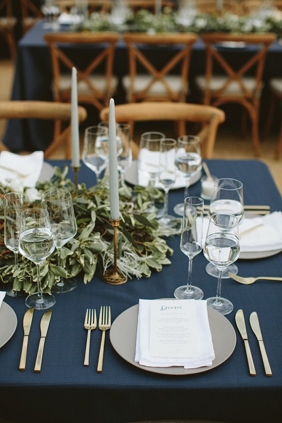 navy blue wedding tablecloth sage candles and greenery décor for navy blue wedding themes for 2023 navy blue and sage green