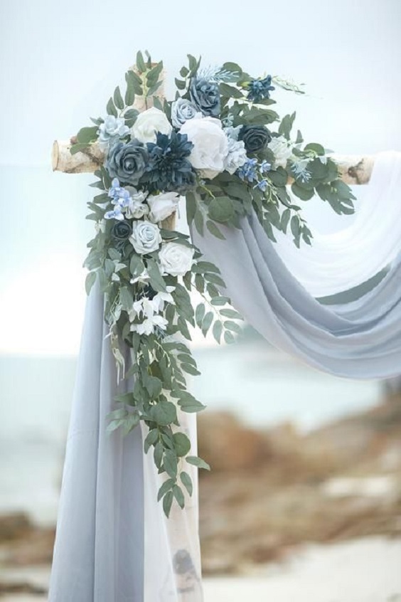 dusty blue cloth wedding arch with dusty blue and grey flowers for dusty blue wedding themes for 2023 dusty blue and grey