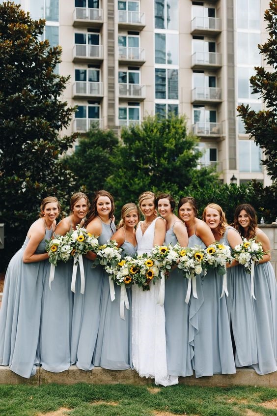 dusty blue bridesmaid dresses white bridal gown white and yellow bouquets for dusty blue wedding themes for 2023 dusty blue and yellow