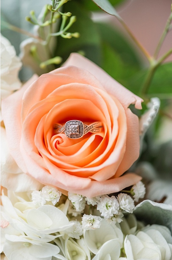 wedding rings hidden in peach flower for great summer wedding color palettes for 2024 peach white and green