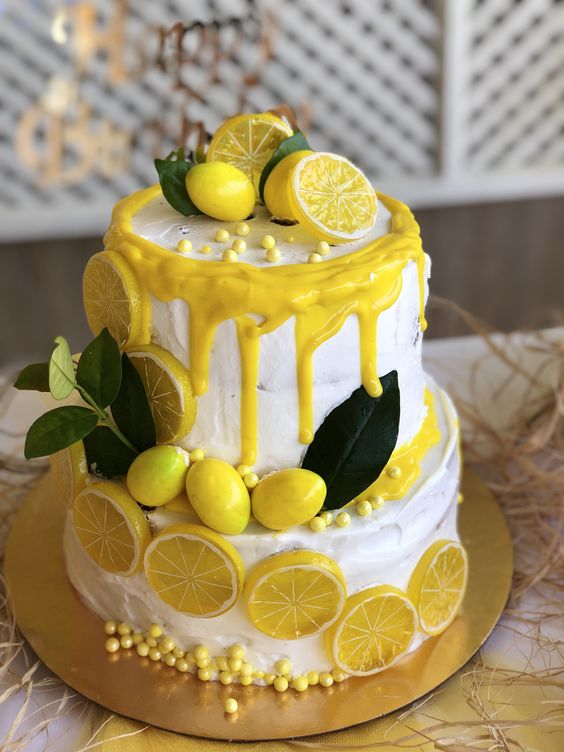 white and yellow creamed weddding cake with lemon décor for great summer wedding color palettes for 2024 navy blue and yellow