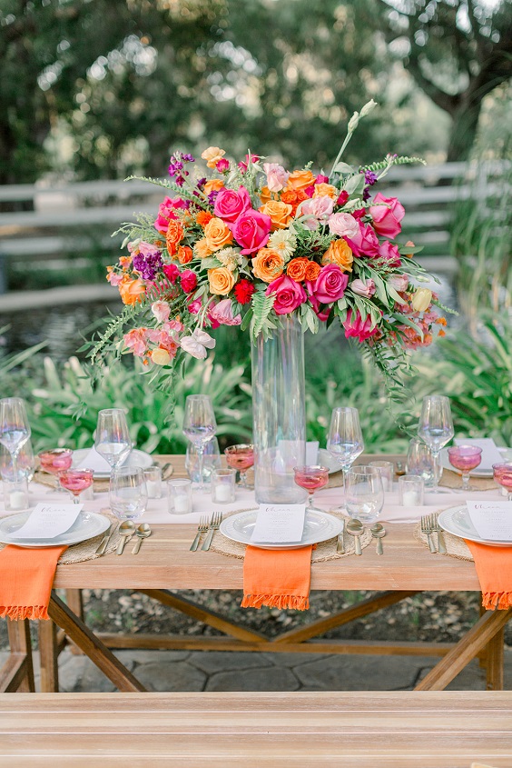 pink and coral wedding flower centerpieces and orange napkins for great summer wedding color palettes for 2024 pink coral and orange