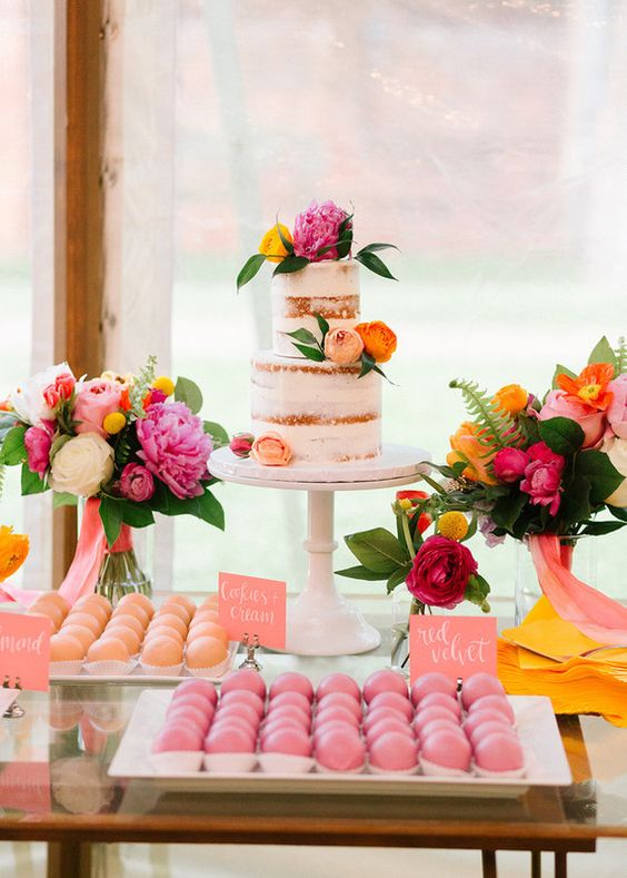 wedding cake dotted with pink and orange flowers pink and orange wedding deserts for great summer wedding color palettes for 2024 pink coral and orange