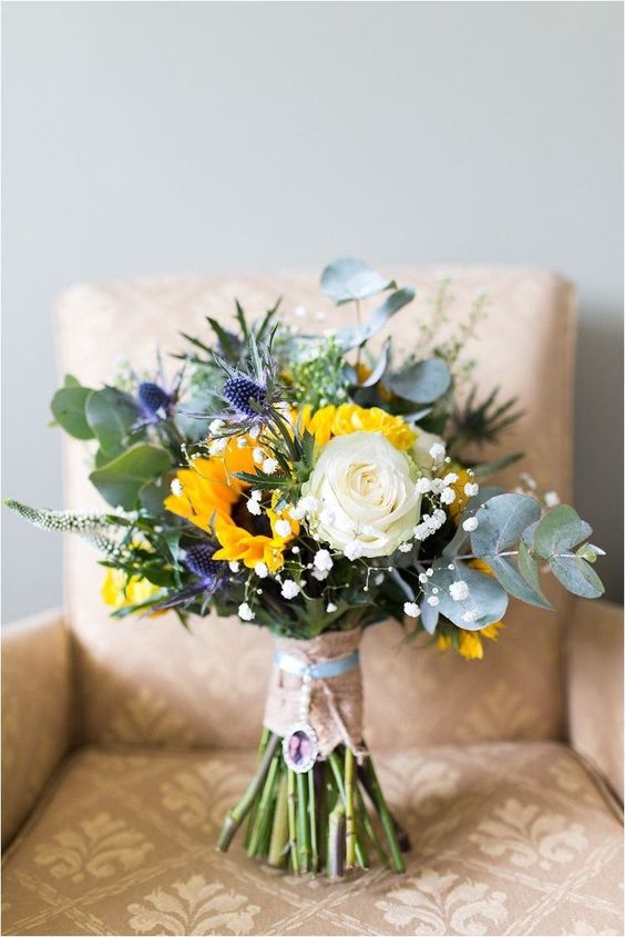 sunflower bouquet on sofa for 8 awesome sunflower wedding color ideas 2024 dusty blue