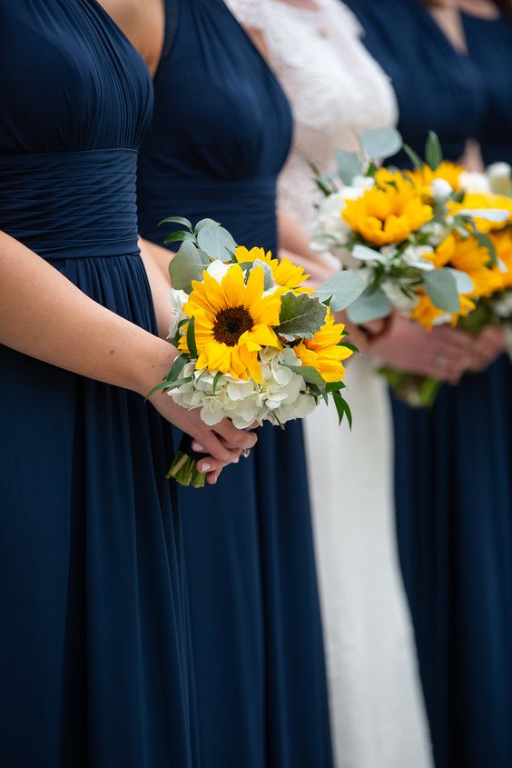 navy blue bridesmaid dresses and sunflower bouquets for 8 awesome sunflower wedding color ideas 2024 navy blue