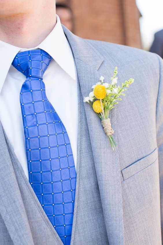 light grey bridegroom suit with royal blue tie and yellow flower boutonniere for royal blue wedding colors 2024 royal blue and yellow