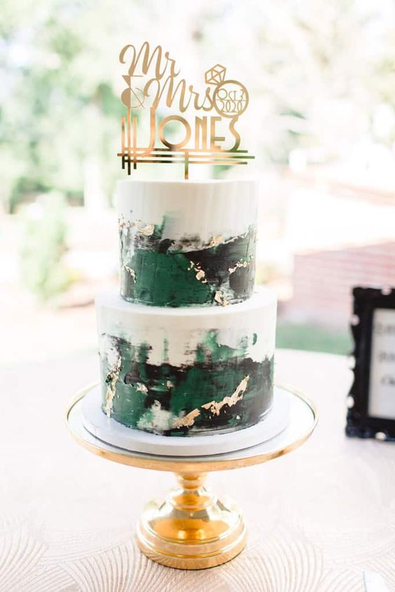 white black and emerald wedding cake with gold wedding topper for december wedding colors 2024 emerald green black and gold