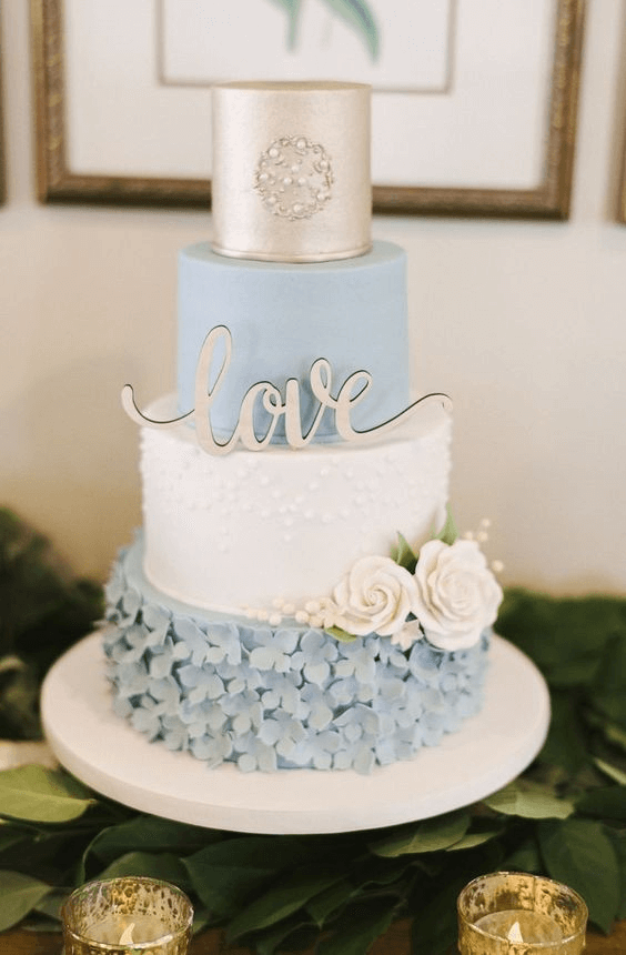 ice blue white gold wedding cake with champagne light blue flowers for march wedding colors combos for 2024 ice blue and white