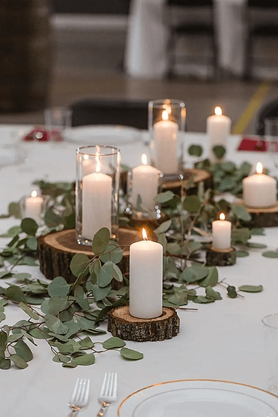 green greenery and white candles wedding centerpieces for march wedding colors combos for 2024 sage green and whisper white