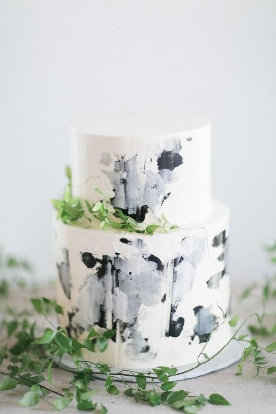 white wedding cake with black ombre cream and greenery décor for january wedding colors for 2024 black white and greenery