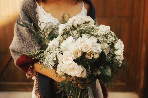 white flower and greenery bridal bouquet for january wedding colors for 2024 gold white and greenery\