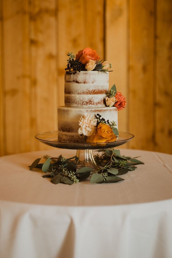 nude wedding cake dotted with burnt orange flowers for burnt orange wedding colors for 2024 burnt orange and sage green