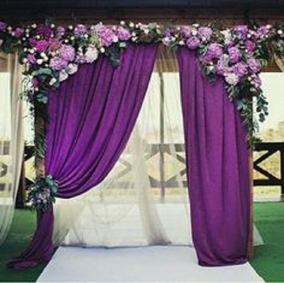 royal purple ceremony backdrop with chalk violet flowers for purple wedding colors combos for 2024 royal purple and chalk violet