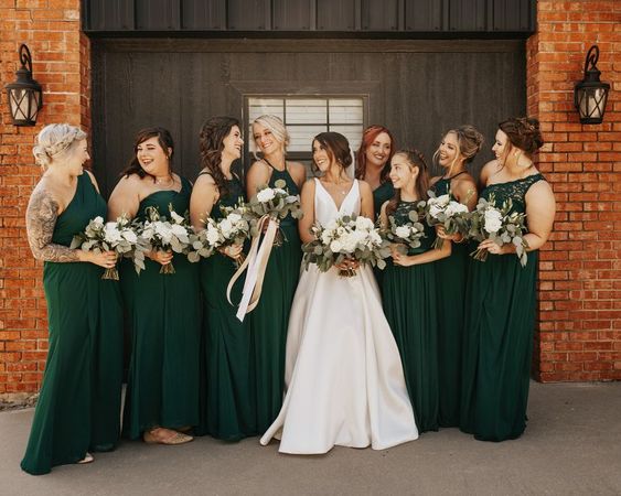 white bridal gown and hunter green bridesmaid dresses for july wedding colors combos for 2024 hunter green and ivory