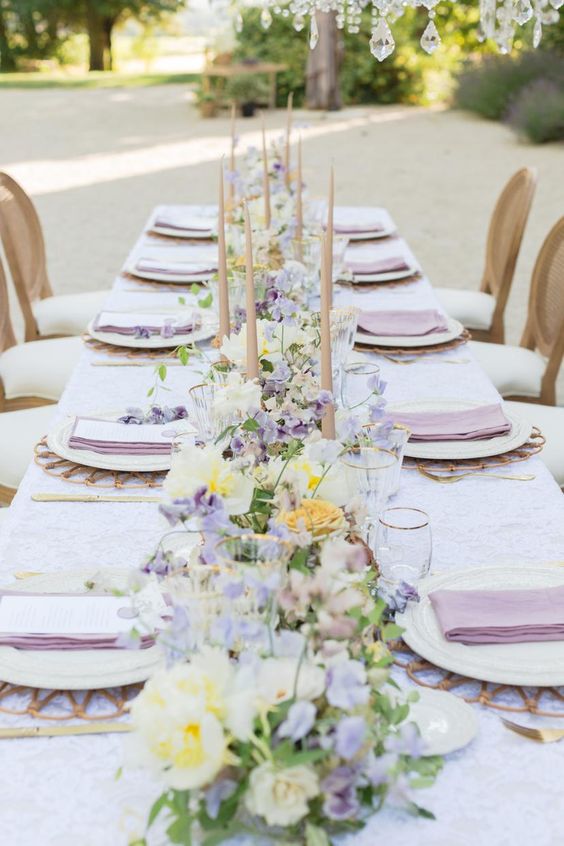 pastel lilac kerchief and pastel lilac white yellow flowers at table for july wedding colors combos for 2024 pastel lilac and white