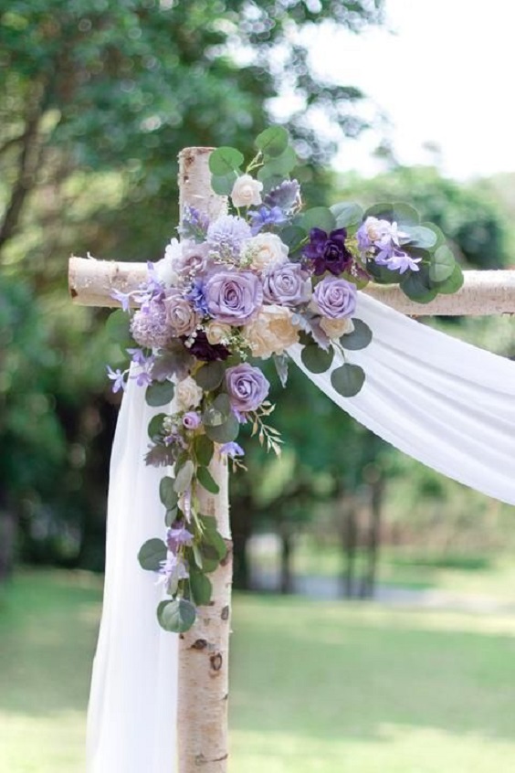 white wedding arch with pastel lilac and champagne flowers for july wedding colors combos for 2024 pastel lilac and white