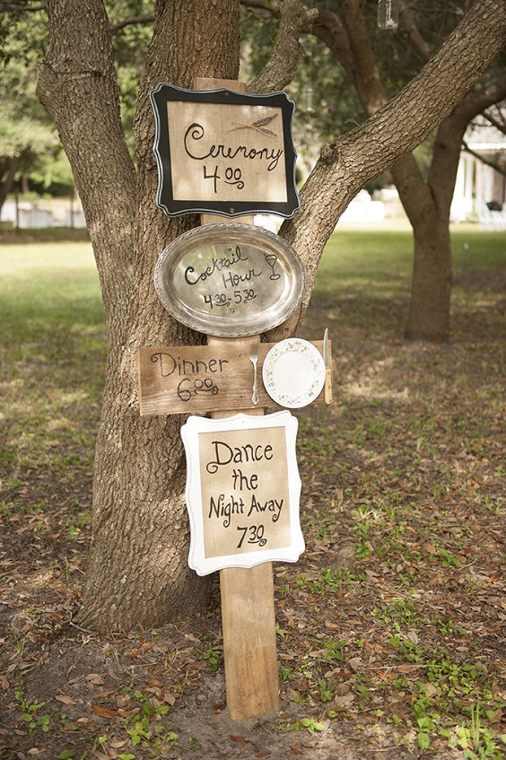 navy and brown wedding direction sign under old tree for country wedding colors for 2025 navy blue blush and brown