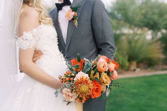 red and orange floral and greenery bridal bouquet for navy blue wedding colors for 2025 navy blue red orange