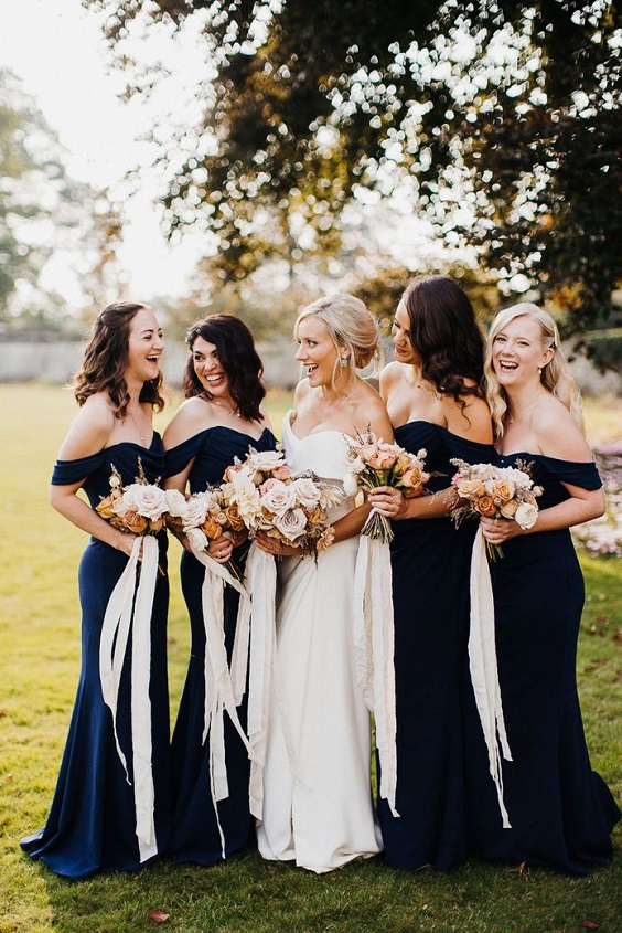 navy blue bridesmaid dresses and white bridal gown for navy blue wedding colors for 2025 navy blue beige and burnt orange