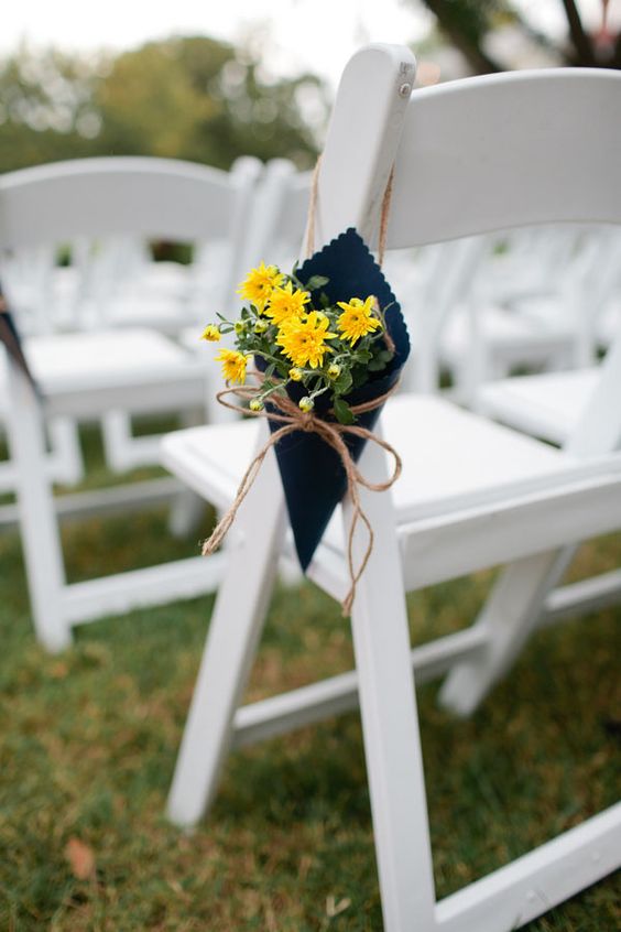 wedding aisle chair decorated with yellow flowers in a navy blue cloth for navy blue wedding colors for 2025 navy blue and yellow