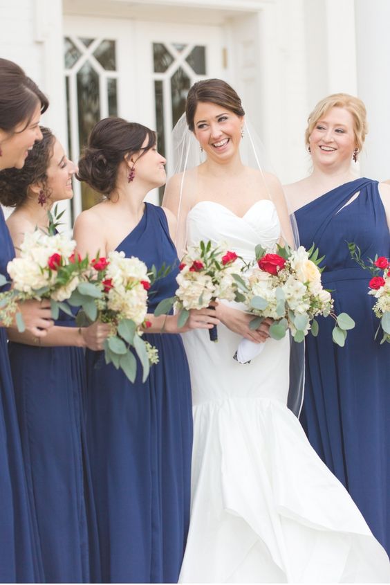 navy blue bridesmaid dresses and a white bridal gown for blue wedding colors combos for 2025 navy blue and red