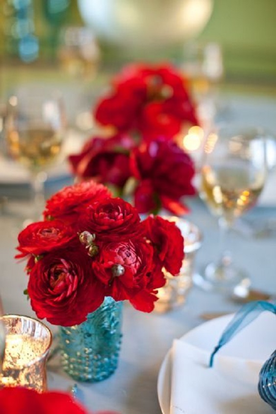 turquoise bottles with red flowers at table for blue wedding colors combos for 2025 turquoise and red