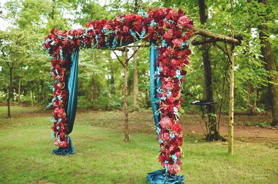 wedding arch with turquoise clothes and red flowers for blue wedding colors combos for 2025 turquoise and red