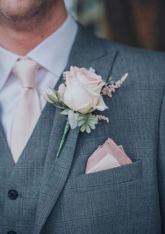 Grooms attire with light pink tie and a flower for june wedding colors combos for 2025 light pink and pink