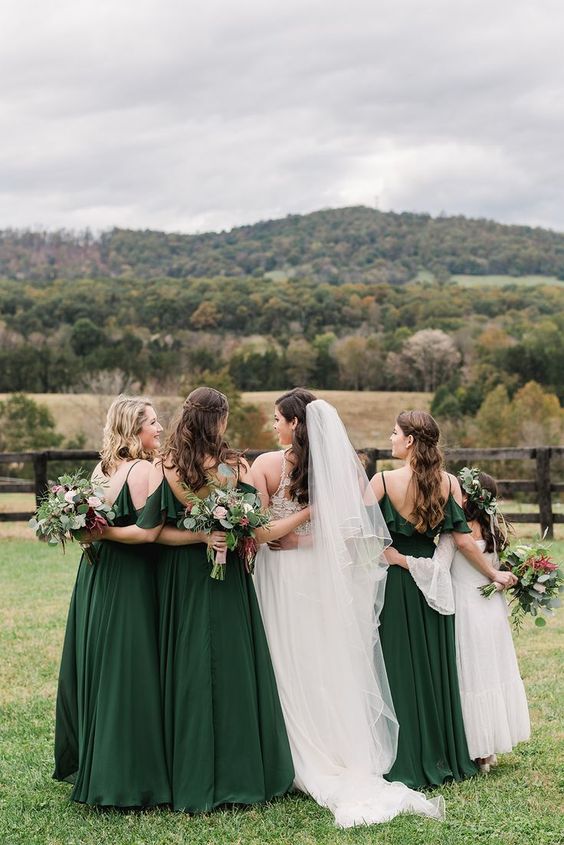 dark green bridesmaid dresses and white bridal gown and a white junior bridesmaid dress for june wedding colors combos for 2025 dark green and cream