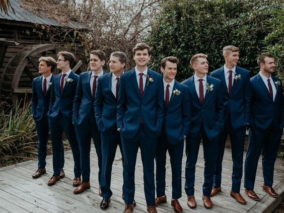 navy blue bridegroom and groomsmen suits and burgundy ties for burgundy wedding colors for 2025 burgundy and navy blue