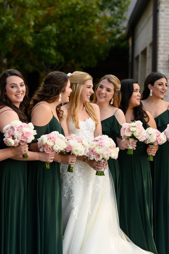 dark green bridesmaid dresses and a white bridal gown for may wedding colors combos for 2025 dark green and pink