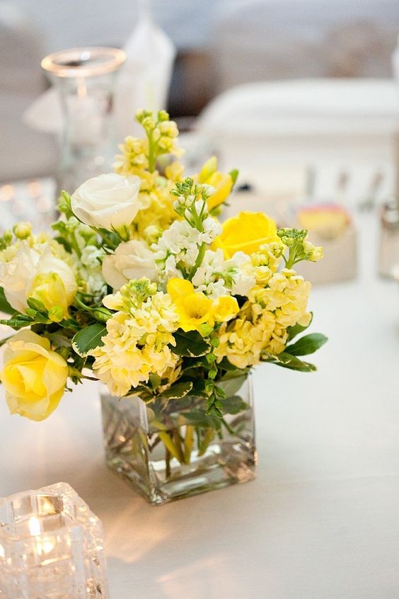yellow and white flowers at wedding table for may wedding colors combos for 2025 yellow and white