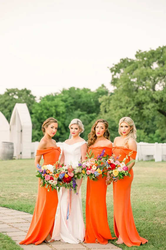 orange bridesmaid dresses and a white wedding gown for may wedding colors combos for 2025 orange and yellow