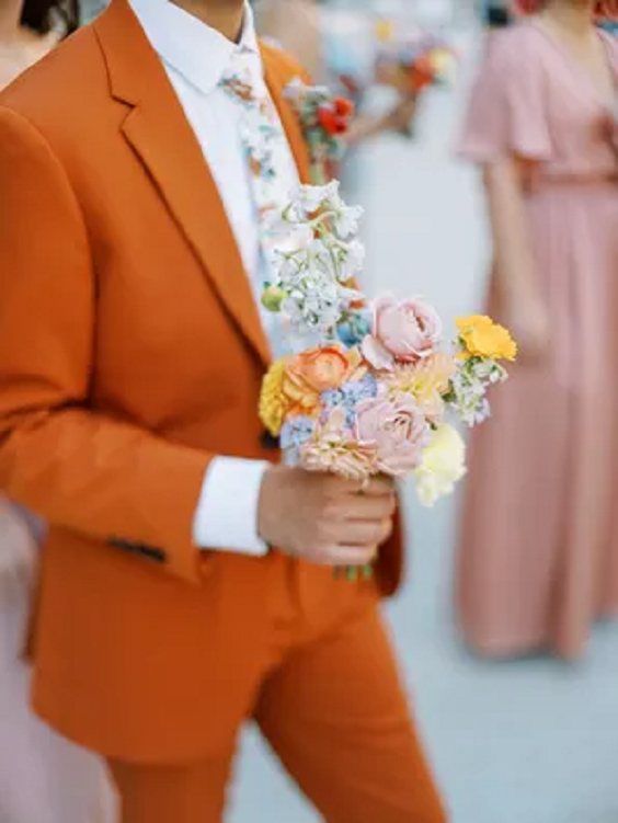 orange groom attire with yellow pink and ice blue bouquets for may wedding colors combos for 2025 orange and yellow
