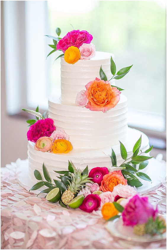 wedding cake with hot pink orange and dusty rose flowers for april wedding colors combos for 2025 hot pink and dusty rose