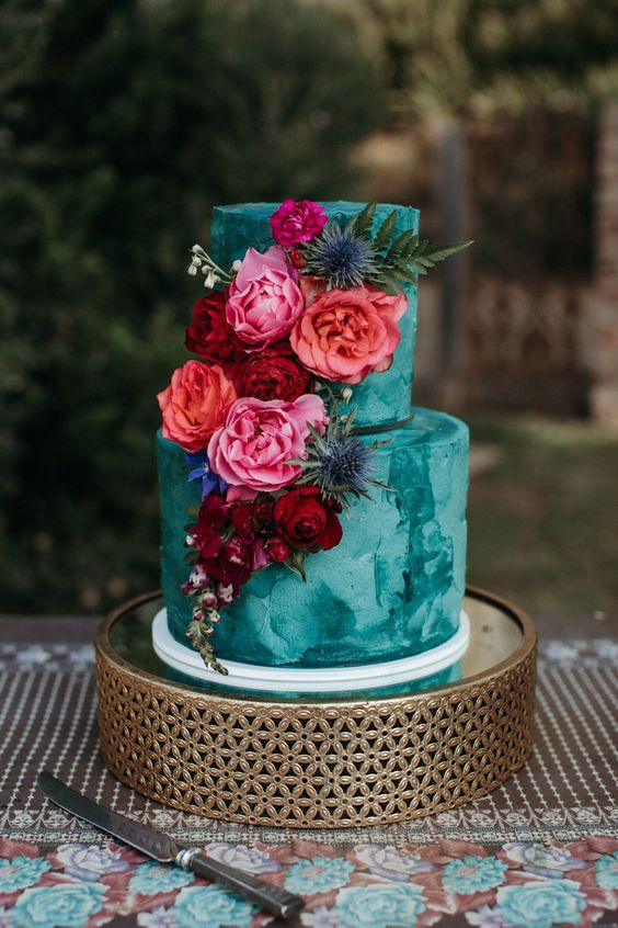 teal wedding cake with pink peach and red flowers for april wedding colors combos for 2025 teal red and pink
