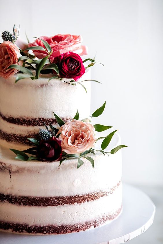 wedding cake with dark red and pink flowers for april wedding colors combos for 2025 dark red cream and pink