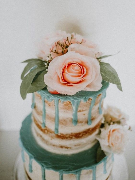 nude wedding cake with peach cream and peach flower décor for teal wedding colors for 2025 teal peach and greenery