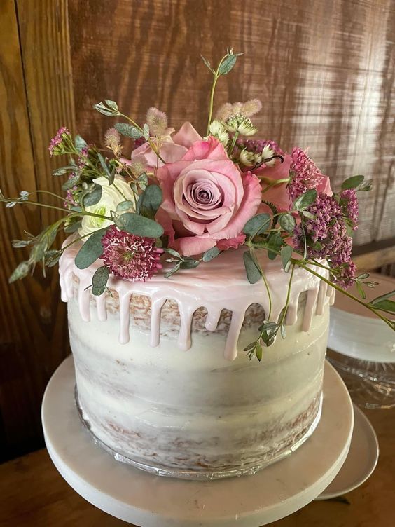nude wedding cake dotted with dusty rose and blush flowers for teal wedding colors for 2025 teal dusty rose and blush