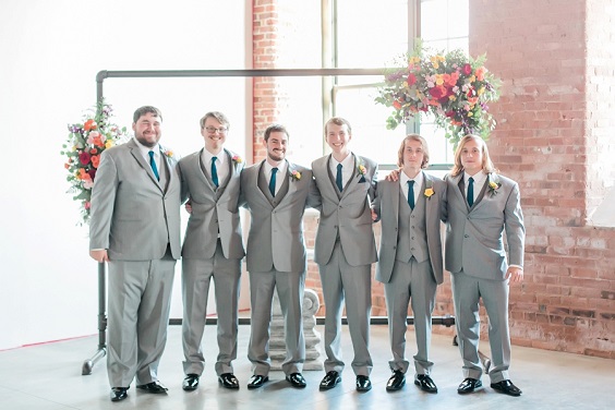 grey groomsmen suits teal ties and yellow flowers corsages for teal wedding colors for 2025 teal and rich colors
