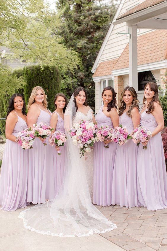 a white wedding gown and light purple bridesmaid dresses for july wedding colors combos for 2025 light purple and pink