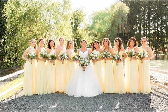 a white bridal gown and pastel yellow bridesmaid dresses for july wedding colors combos for 2025 pastel yellow and yellow
