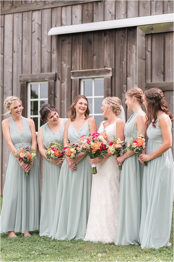 sage green bridesmaid dresses and a white wedding gown for summer wedding colors combos for 2025 sage green and mango